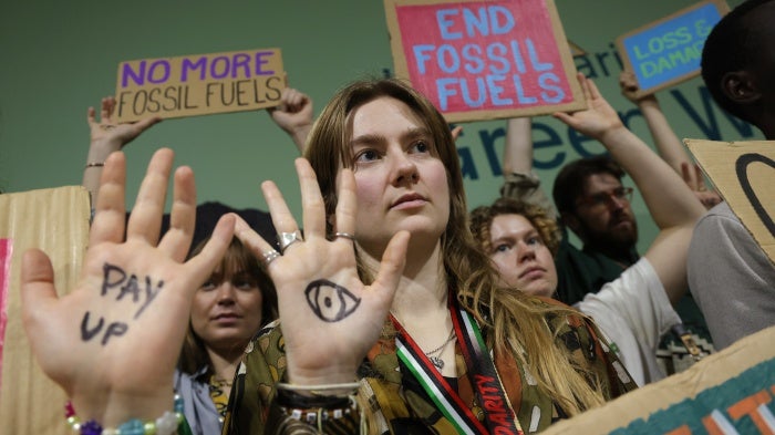 Activists with painted hands protest against fossil fuels and for climate finance at the COP29 Climate Conference in Baku, Azerbaijan, November 22, 2024.